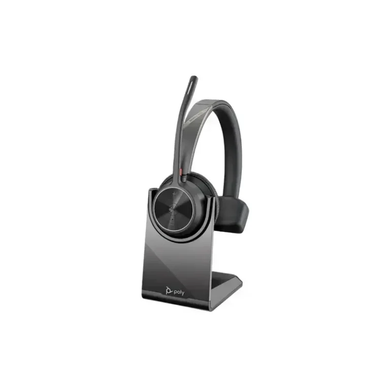 Poly Voyager 4310 M Teams headset with upright boom microphone resting on a black desktop charging stand.