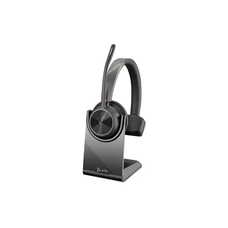 Poly Voyager 4310 M Teams headset with upright boom microphone resting on a black desktop charging stand. Poly Voyager 4310 M Teams headset with upright boom microphone resting on a black desktop charging stand.